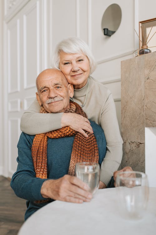 old man and woman hugging